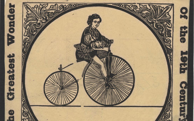 Black-and-white image of person on early bicycle