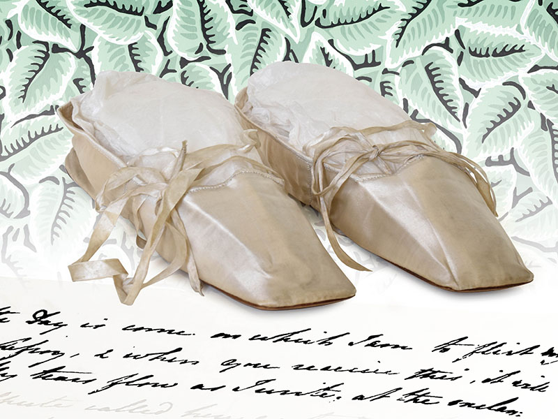 A pair of delicate ivory-coloured lace-up satin slippers from the Georgian period