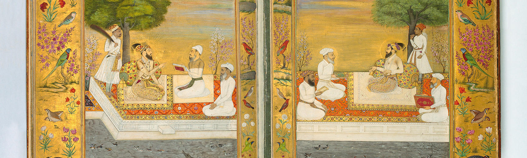 A manuscript illustration of men sitting at a table in a garden; the borders of the illustration are gold and decorated with birds and plants