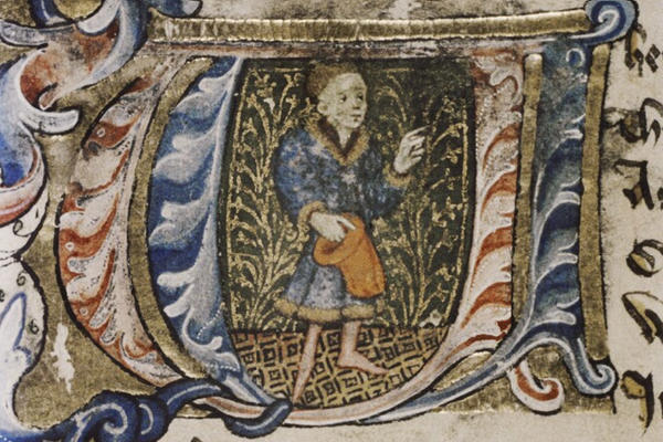 An illuminated letter W showing a picture of a man 